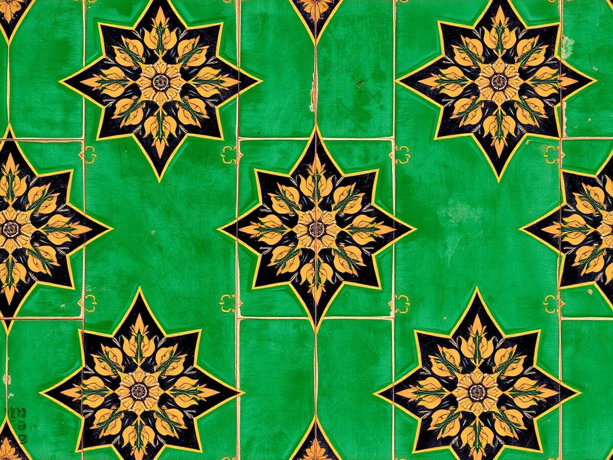 Glazed emerald, black and gold star-and-cross tilework with floral medallions